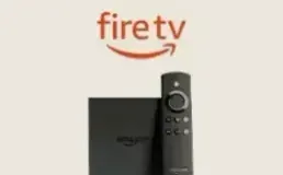 Amazon Fire TV Stick beside its voice remote